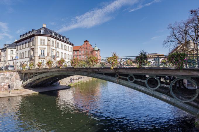 Strasbourg, France - October 25, 2021: Ill River canal with promenade and row of town houses